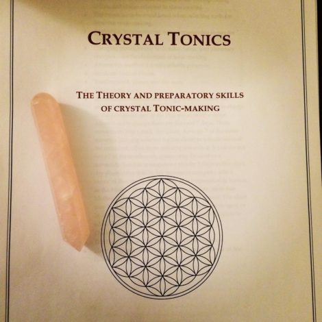 Crystal Tonics - Manual with crystal laying on paper for a course taught by Frater Ipafs