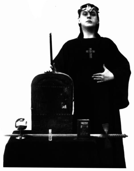 Aleister Crowley posing as Magus with the Stelae of revelation and magical weapons: wand, chalice, sword and the Book of the Law – the Liber Al Vel Legis