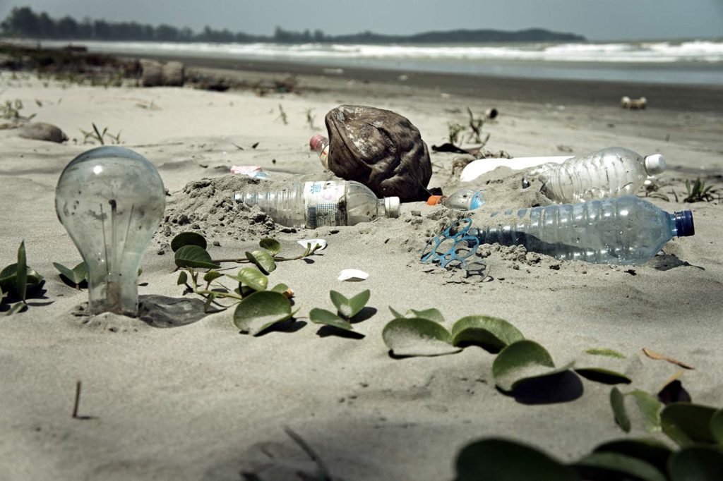 Pollution caused by inorganic compounds. Plastic waste at the sea. 
