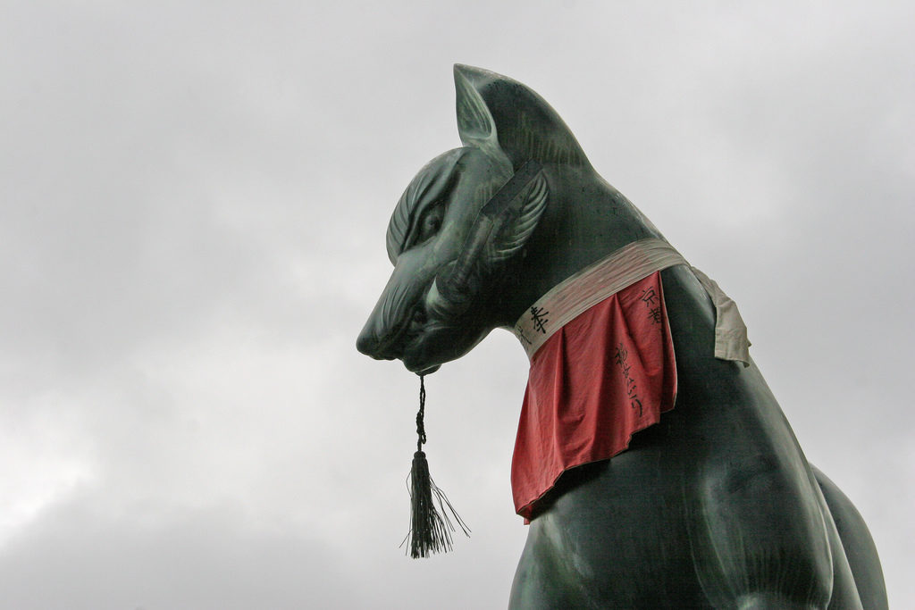 Japanese fox Kitsune statue with red decoration - yodarekake