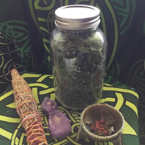 Witch jar with dried nettle leaves and nettle smudge for ritual use.