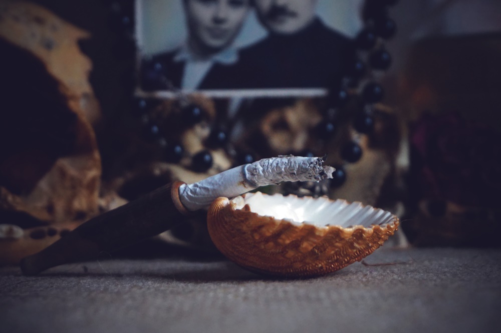 Offering on witches altar: burning cigarette in seashell